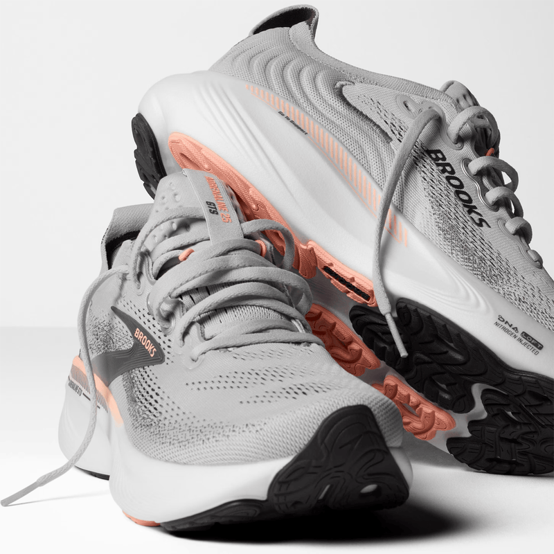 Load image into Gallery viewer, Gray running shoes with orange accents and 'Brooks' branding on a white background
