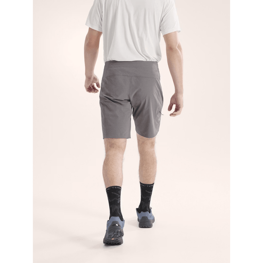 Person wearing gray shorts on a white background