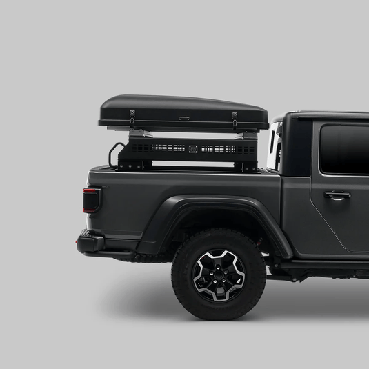 Gray pickup truck with a roof box on a gray background