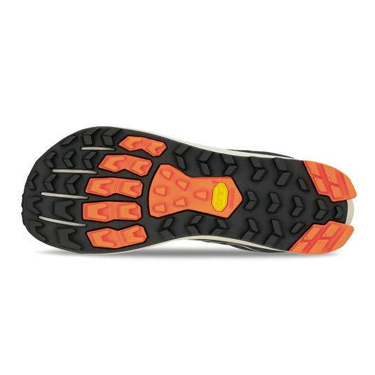 Close-up of a shoe sole with orange and black pattern on a white background