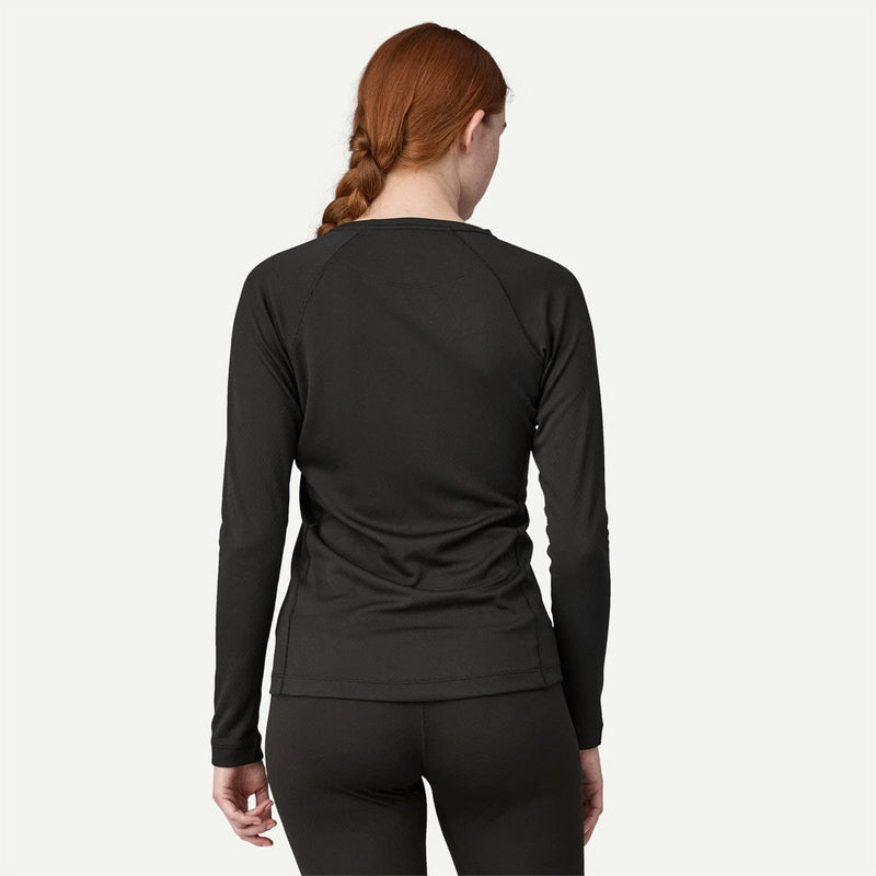 Load image into Gallery viewer, Person wearing a black long-sleeve athletic top on a white background
