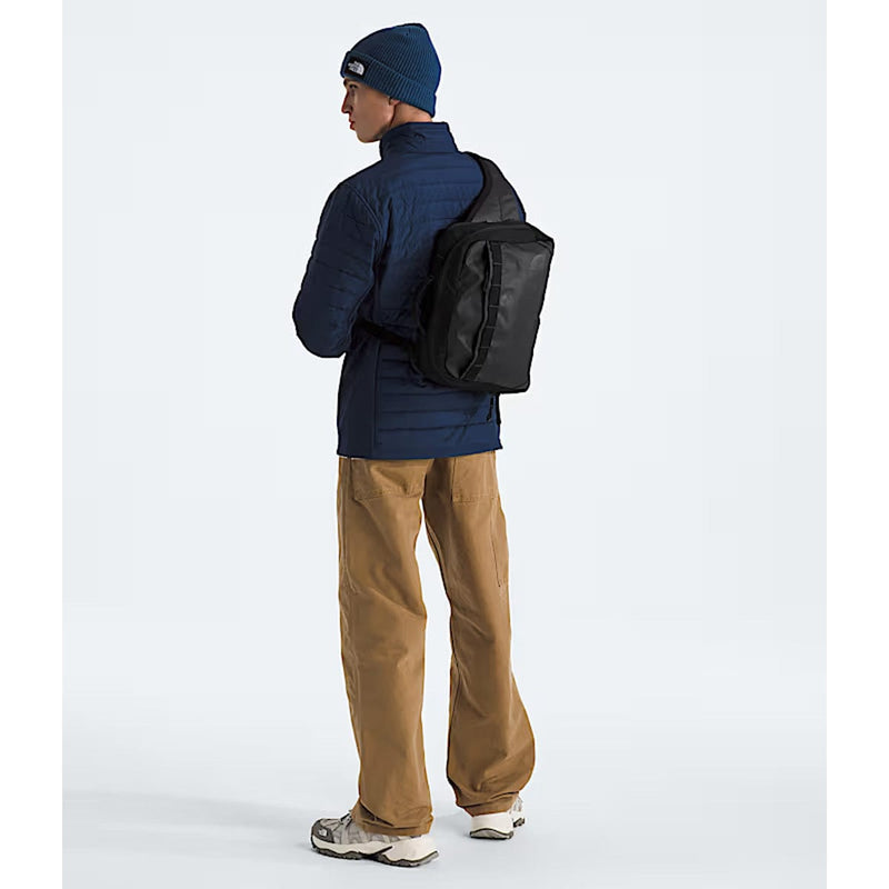 Load image into Gallery viewer, Person wearing a navy jacket, brown pants, and a black backpack on a white background
