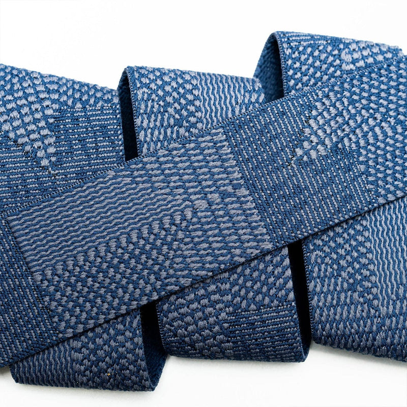 Load image into Gallery viewer, Close-up of a blue textured fabric roll on a white background
