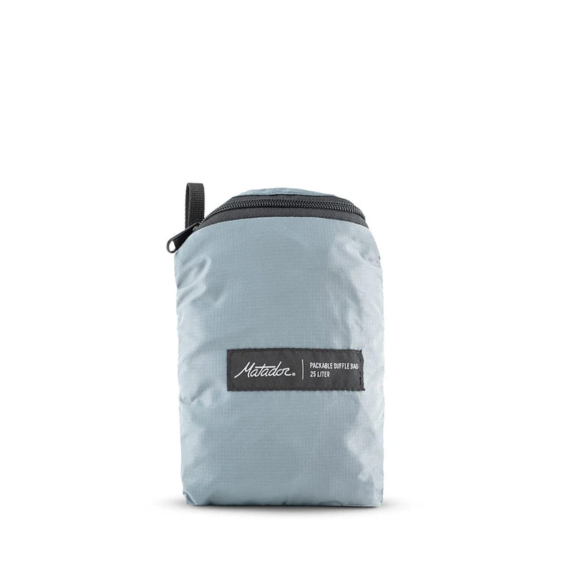 Load image into Gallery viewer, Light blue duffel bag with a black zipper and brand label on a white background
