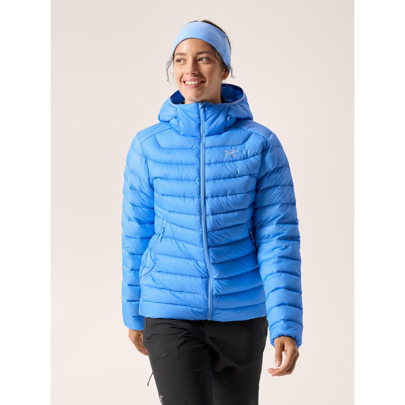 Load image into Gallery viewer, Person wearing a blue puffer jacket with a hood on a light background
