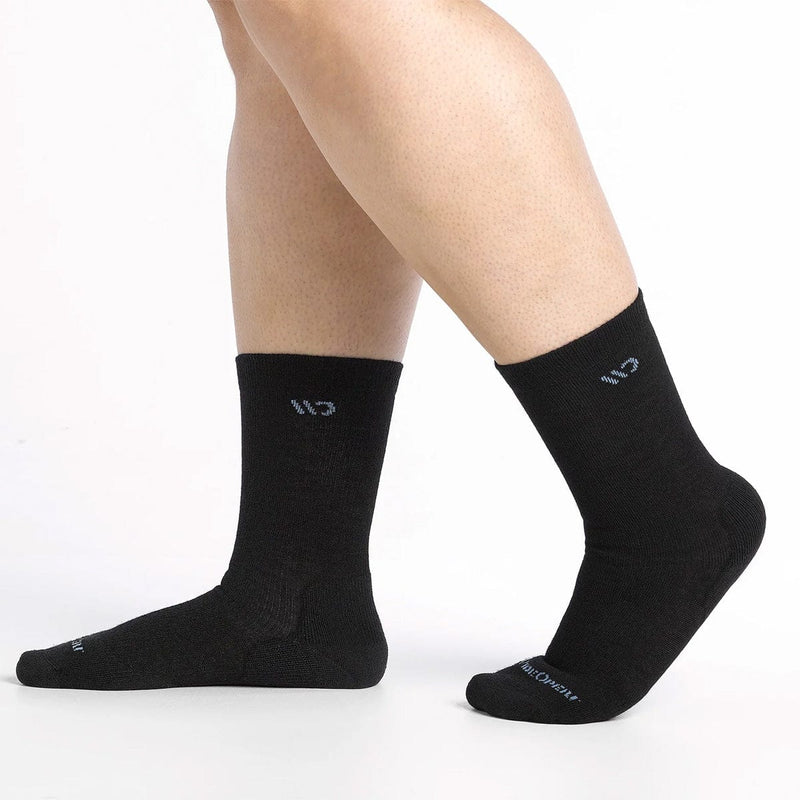 Load image into Gallery viewer, Black socks worn by a person on a white background

