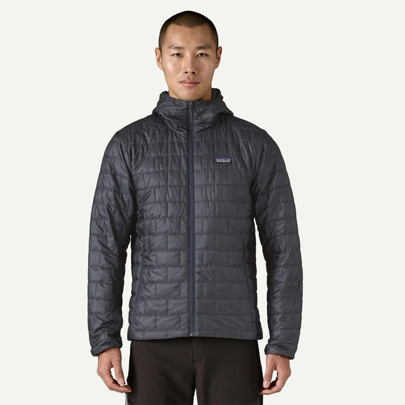 Load image into Gallery viewer, Man wearing a gray quilted jacket with a brand logo on a white background
