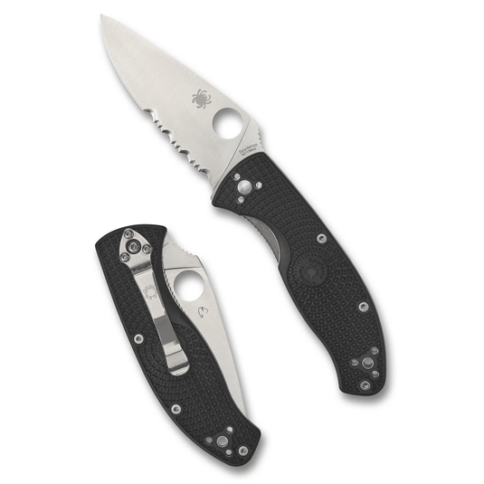 Folding knife with black handle and silver blade on a white background
