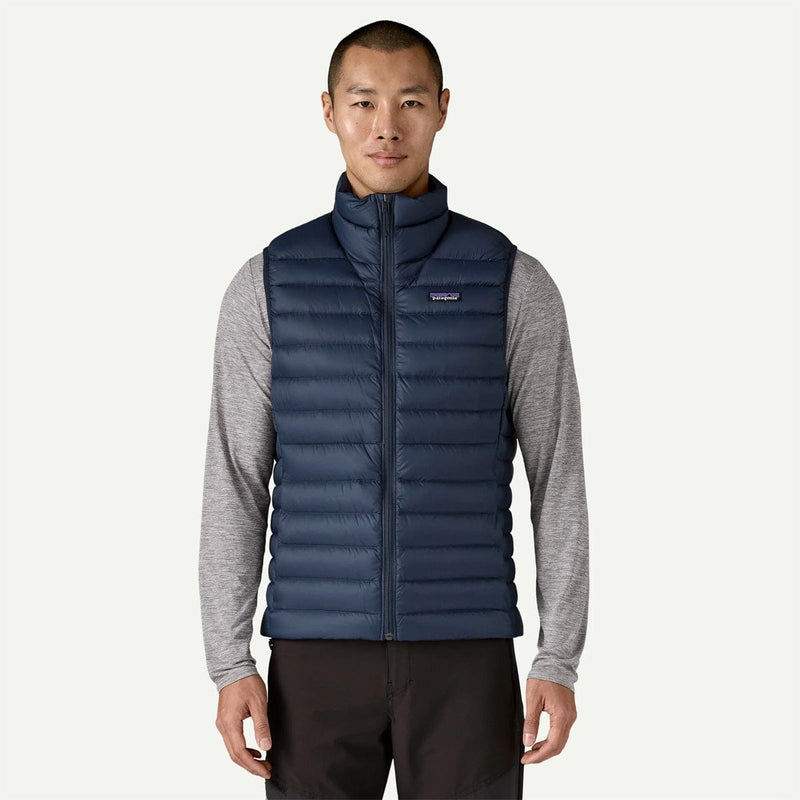 Load image into Gallery viewer, Man wearing a blue puffer vest over a gray shirt on a white background
