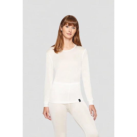Woman wearing a white long-sleeve top and pants on a light gray background