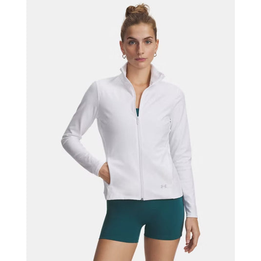 Woman wearing a white jacket and green shorts on a white background
