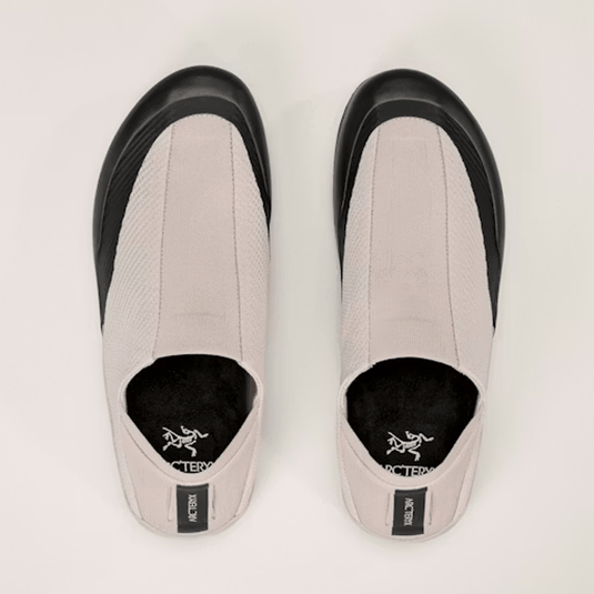 Pair of gray shoes with black soles on a light gray background