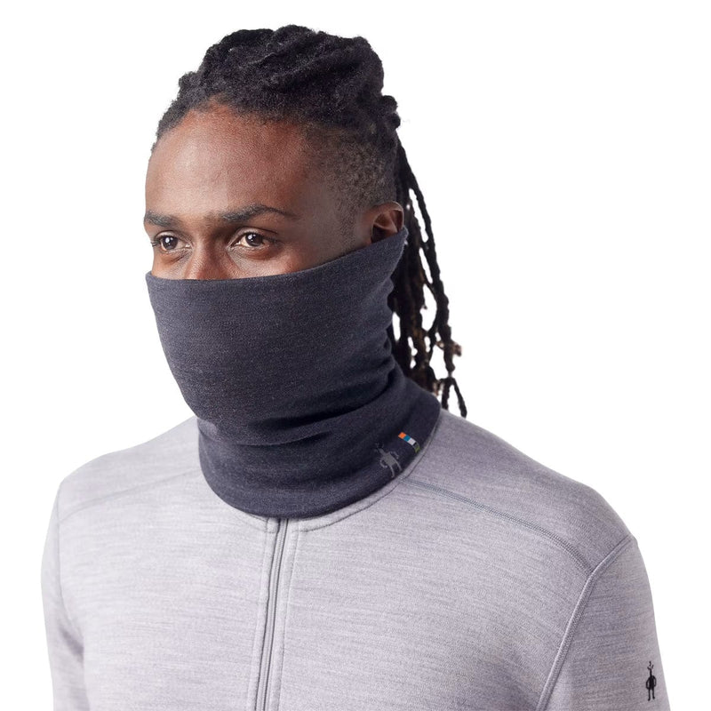 Load image into Gallery viewer, Person wearing a dark gray neck gaiter with a white background
