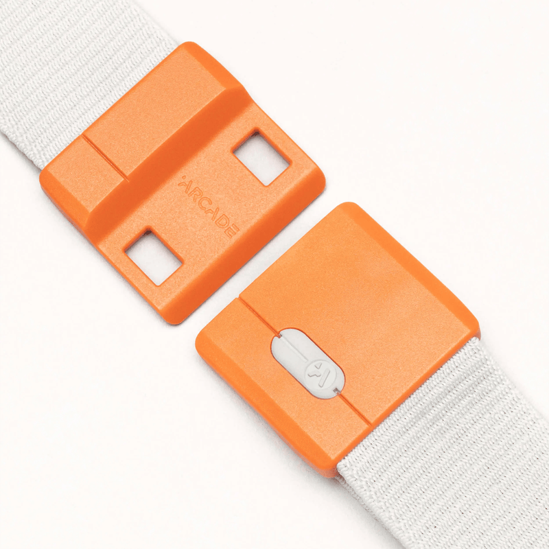Load image into Gallery viewer, Two orange belt buckles with white straps on a light gray background
