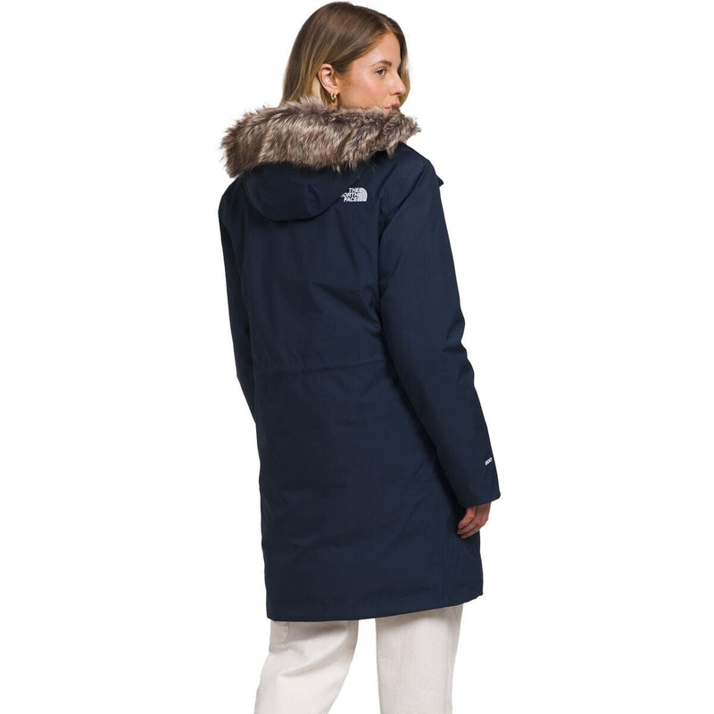 Load image into Gallery viewer, Person wearing a navy blue coat with fur hood on a white background
