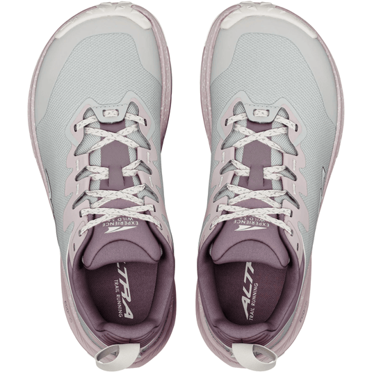 Pair of gray and purple running shoes with white laces on a white background