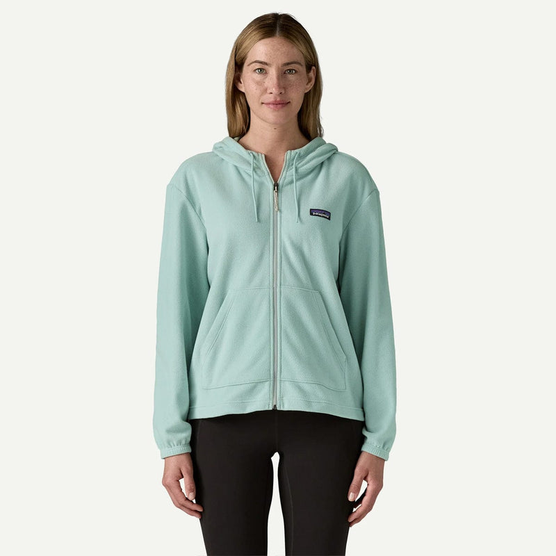 Load image into Gallery viewer, Woman wearing a light blue hoodie with a brand logo on a white background
