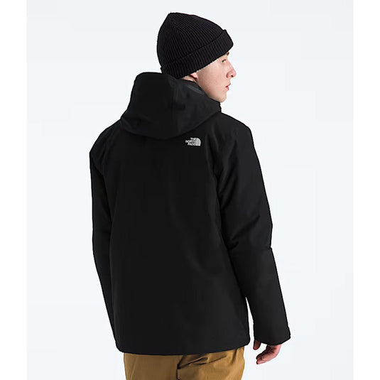 Person wearing a black jacket with a brand logo on a white background