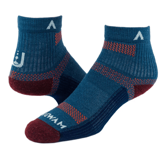 Pair of blue socks with red accents on a white background