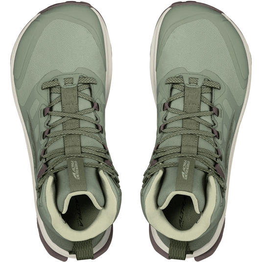 Pair of green hiking boots on a white background