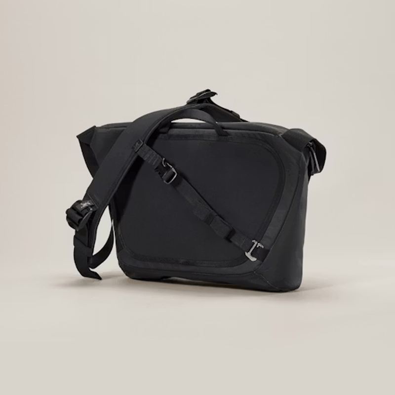 Load image into Gallery viewer, Black shoulder bag on a beige background
