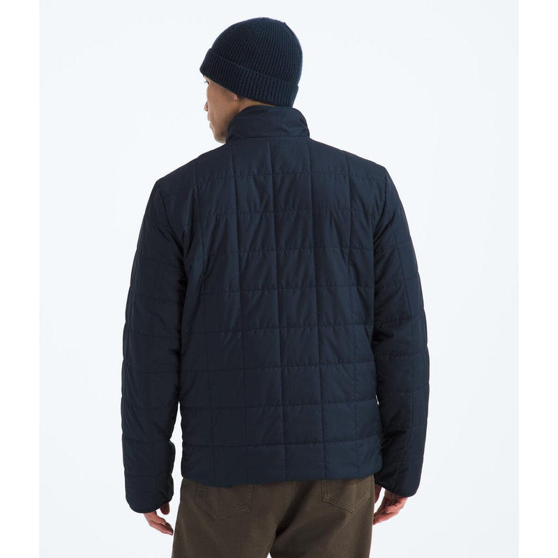 Load image into Gallery viewer, Person wearing a dark blue quilted jacket and beanie on a white background
