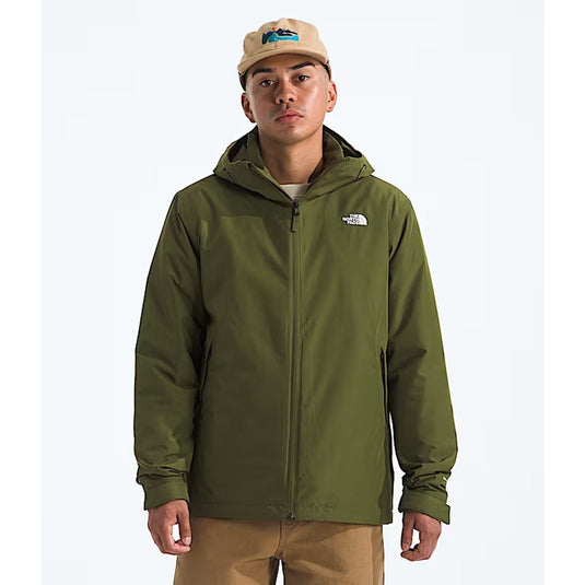 Person wearing a green jacket with a brand logo on a white background