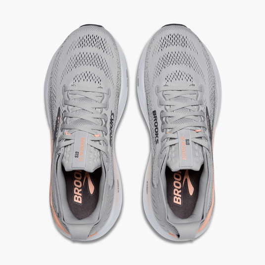 Pair of gray running shoes with 'Brooks' branding on a white background