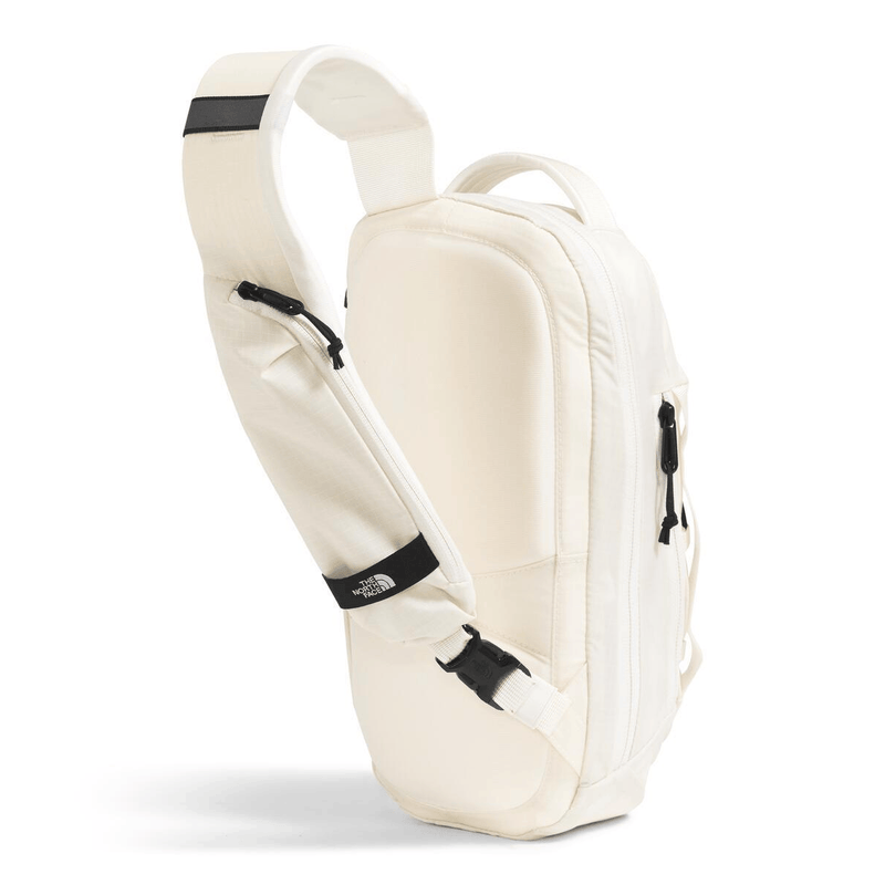 Load image into Gallery viewer, White sling bag with black accents on a white background
