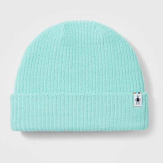 Light blue knit beanie with a small label on a light gray background