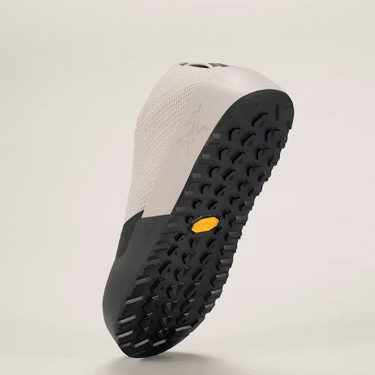 Sole of a shoe with black tread pattern on a light gray background