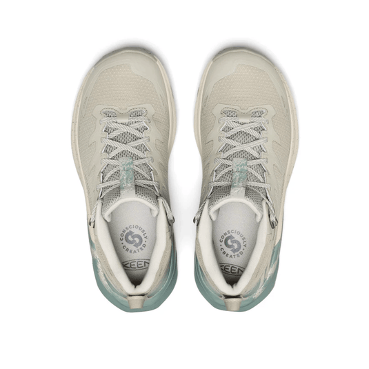 Pair of light gray sneakers with white soles on a white background