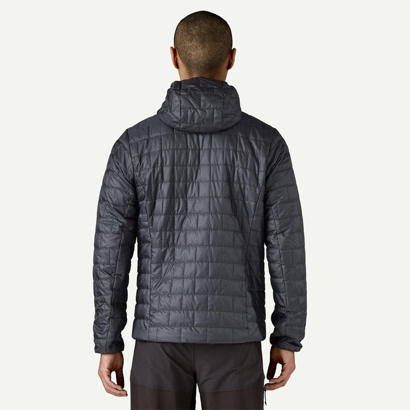 Load image into Gallery viewer, Person wearing a dark gray quilted jacket on a white background
