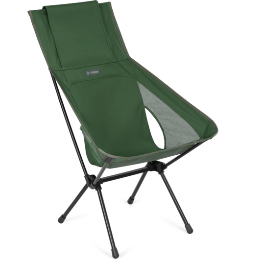 Green camping chair with black legs on a white background