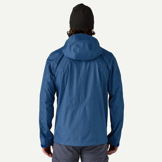 Person wearing a blue raincoat on a white background