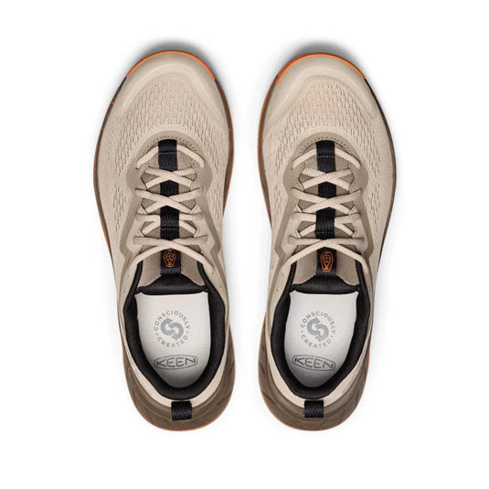 Pair of beige KEEN shoes on a white background
