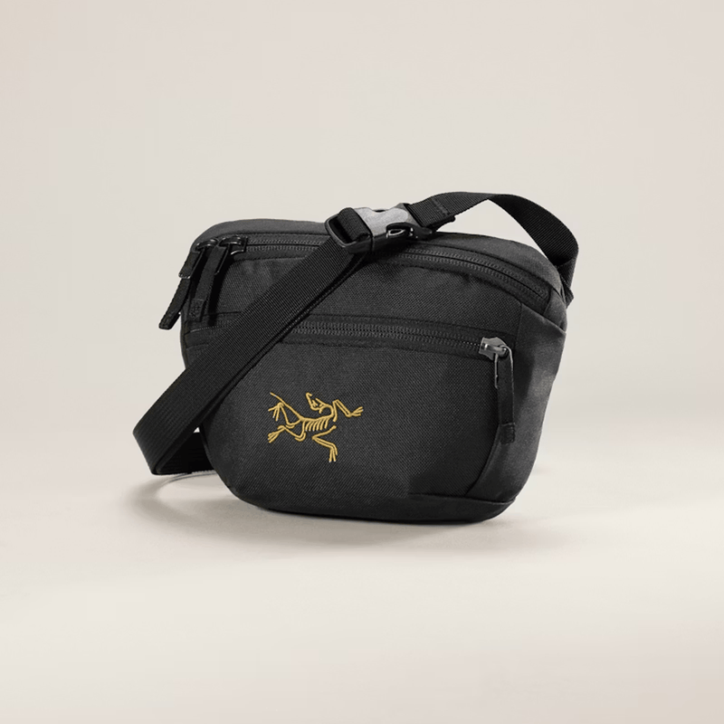 Load image into Gallery viewer, Black crossbody bag with a logo on a beige background
