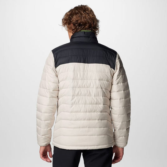 Person wearing a two-tone puffer jacket with black and beige colors on a white background