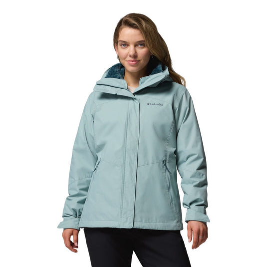 Woman wearing a light blue jacket with Columbia logo on a white background