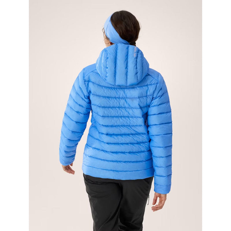 Load image into Gallery viewer, Person wearing a blue puffer jacket on a light beige background
