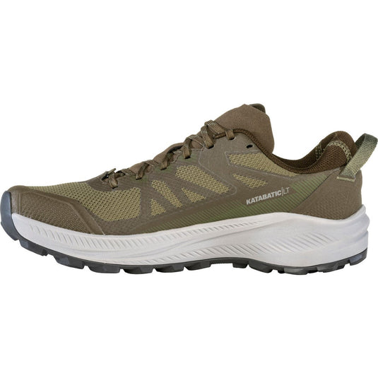 Green hiking shoe with white sole on a white background