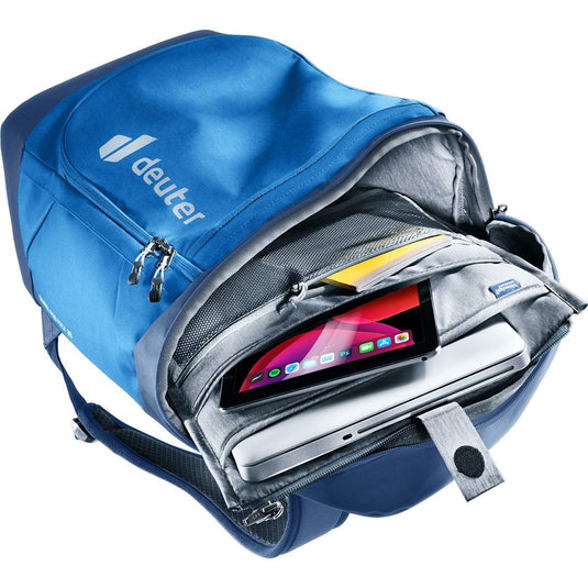 Blue backpack with a laptop and tablet inside, featuring the Deuter brand.