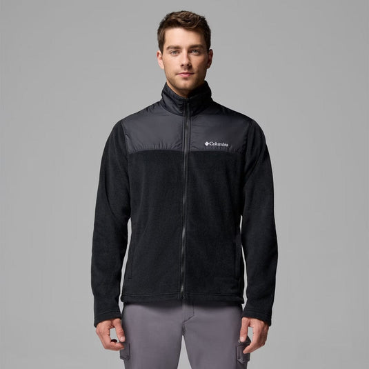 Man wearing a black Columbia jacket on a gray background