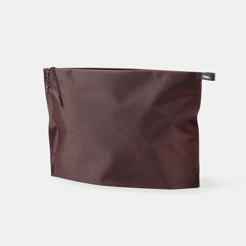 Load image into Gallery viewer, Brown textured pouch with a brand label on a white background
