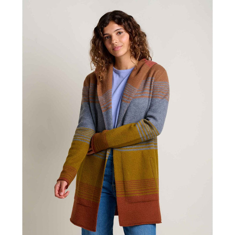 Load image into Gallery viewer, Woman wearing a colorful striped cardigan on a plain background
