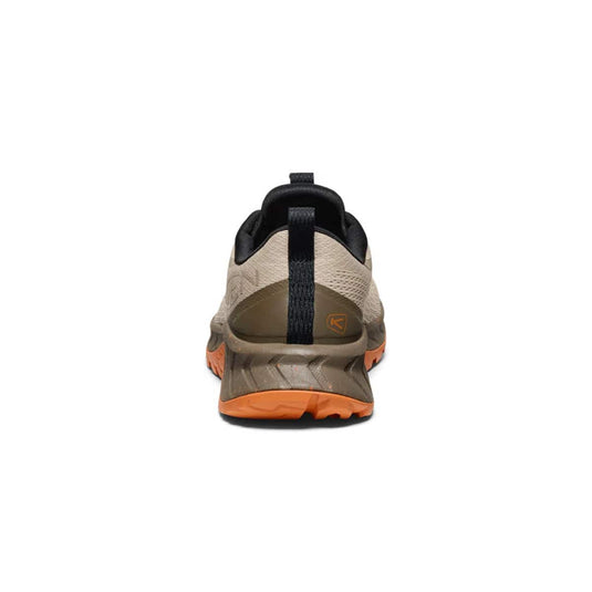 Back view of a hiking shoe with orange sole on a white background
