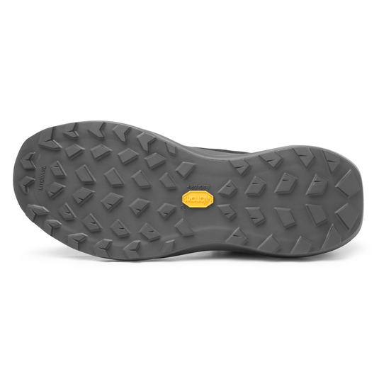 Close-up of a gray shoe sole with a brand logo on a white background