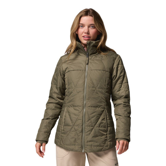 Woman wearing a green quilted jacket on a white background