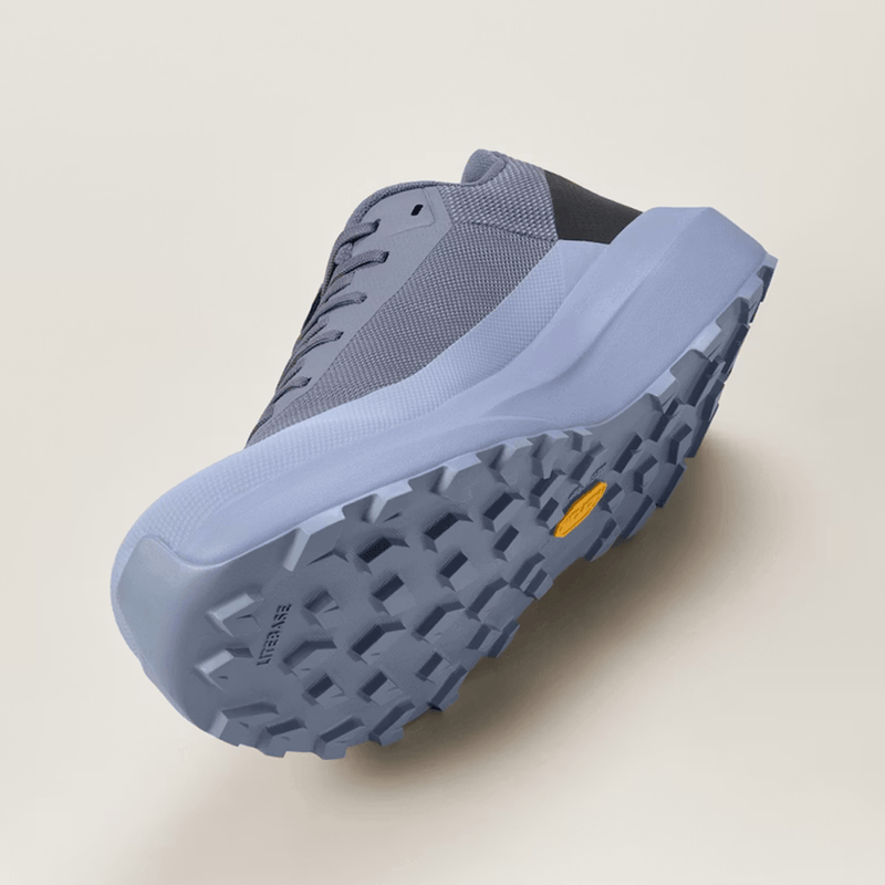 Load image into Gallery viewer, Blue athletic shoe with a textured sole on a light beige background
