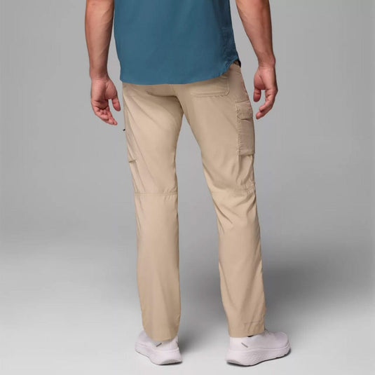 Person wearing beige cargo pants and a blue shirt on a gray background